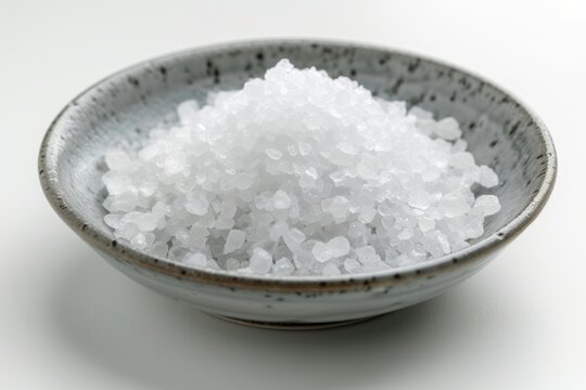 Culinary Grace: The image captures the culinary grace of salt artfully arranged on a plate, presenting an exquisite portrayal isolated against a clean white background.