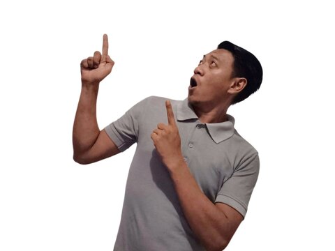 Wow and shock face of young Asian man in gray t-shirt with hands pointing up empty space.