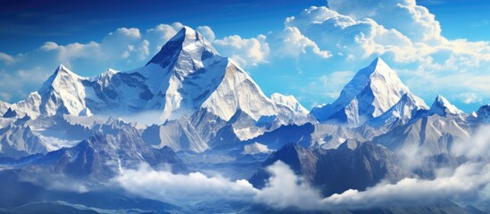 A majestic mountain range covered in snow and clouds stands against an electric blue sky, creating a stunning natural landscape