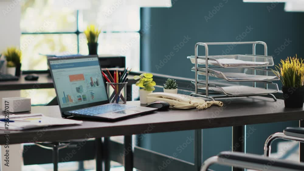 Poster documents on laptop screen in office containing business financial information income statements. co