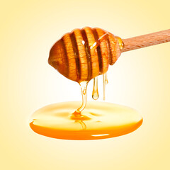 Natural honey dripping from dipper on pale yellow background
