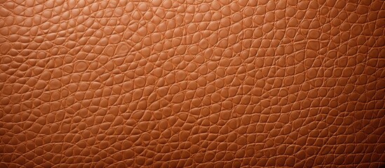 Fototapeta premium A detailed close-up view of a brown leather texture, showcasing the intricate patterns and quality of the material. This texture serves as a perfect background for interior design projects.