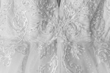 macro close up of wedding dress. A wedding dress or bridal gown is the dress worn by the bride...
