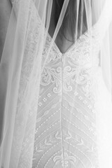 macro close up of wedding dress. A wedding dress or bridal gown is the dress worn by the bride during a wedding ceremony.