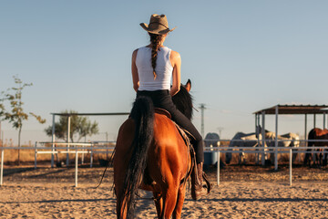 Woman riding a horse in an equestrian center