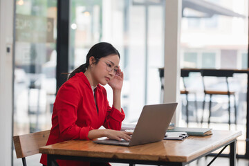 Fototapeta premium Tired and overworked young office worker have a headache while working.