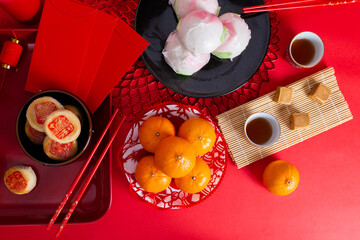 Fototapeta na wymiar Steamed buns, oranges, pans and tea for the Chinese New Year festival