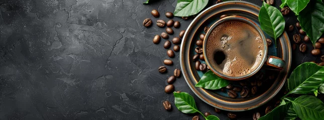 Foto op Plexiglas Espresso in a ceramic cup with coffee beans and green leaves on a dark stone background. © DailyStock