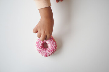 top view of child hand pick chocolate donut
