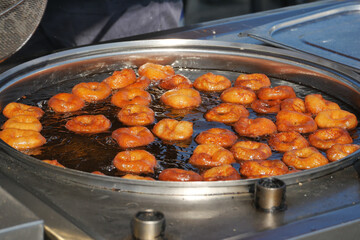 Traditional fried sweets lokma in sugar syrup