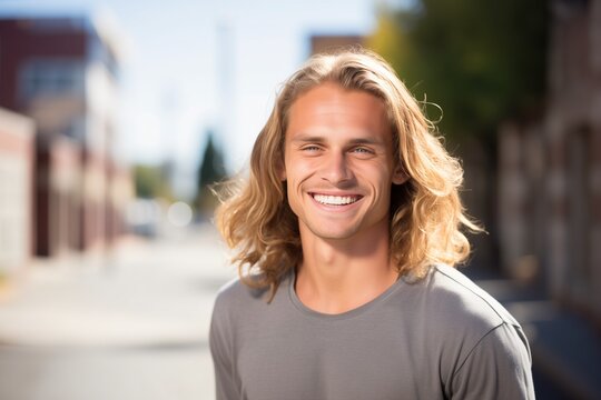 Young caucasian man smiling happy face portrait on a street