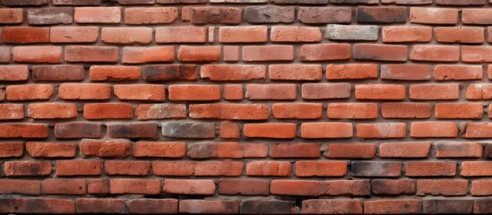 Obraz premium A detailed closeup of a symmetrical arrangement of brown bricks and mortar, showcasing the intricate craftsmanship of a bricklayer in constructing the building material composite wall