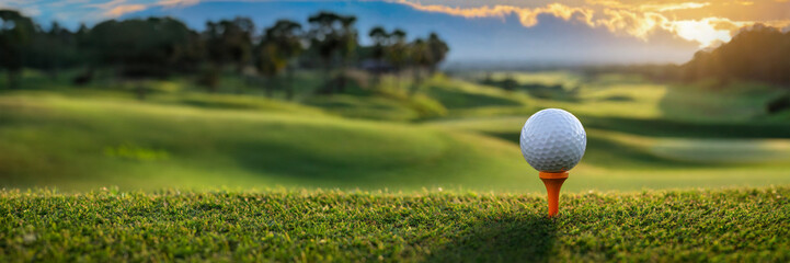 golf course in the evening at sunset with golf ball on tee, panoramic banner, copy space - 755298063
