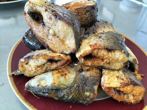 Fried milkfish slices on a plate. Selective focus.
