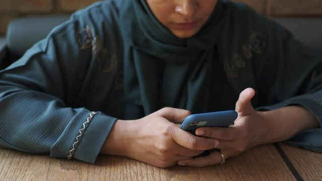  women hand holding smart phone sitting on cafe 