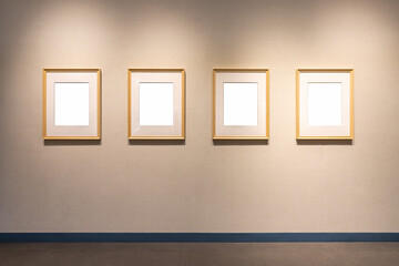 four blank wooden picture frames on wall