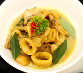 Top View. Stir-fried squid in Curry Powder die cut in the white bowl. Selective focus.
