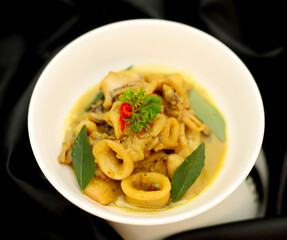 Top View. Stir-fried squid in Curry Powder die cut in the white bowl. Selective focus.
