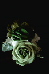 A boutonni&egrave;re is a floral decoration, typically a single flower or single stick, worn on the lapel of a tuxedo or suit jacket.