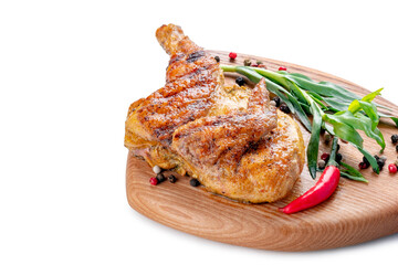Half of a fried small chicken on a wooden board on a white background, close up