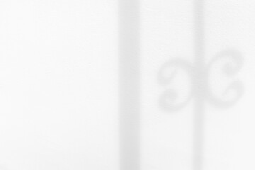 White concrete wall with shadow of fence overlay effect. Minimal blurred backdrop backgrounds. Summer surface background.	Sunlight shining through the wall. 