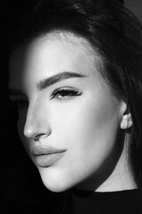 Fototapeta premium Surrealist portrait of young lady with art makeup. Black and white photography of beautiful women with smoky-eyes eyeshadows
