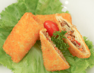 Fish Risol filled with smoked fish  and chilli sauce, served with parsley, tomato and lettuce. The concept of modernized Indonesian traditional snacks.
