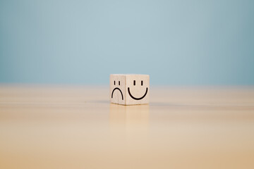 Emotional state and mental health concept, Smile face on bright side and sad face on dark side of...