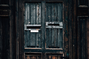 Old dark wooden door close-up of mail box. Ancient architecture and texture of the city street 