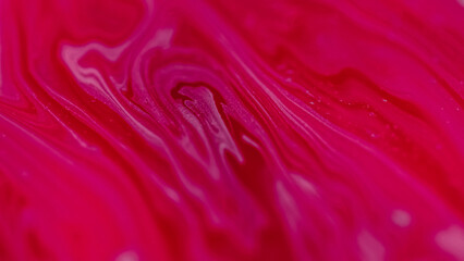 Paint swirl. Glitter liquid mix. Defocused pink red color marble texture ink water blend vortex...