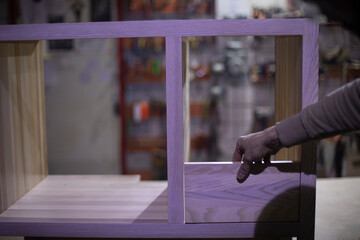 Manufacture of furniture. Guy holds board. Joinery.
