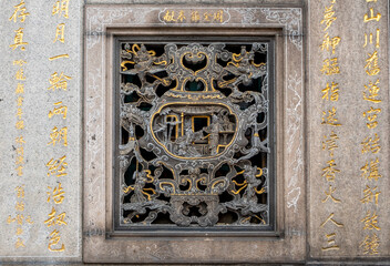 Detail of ornate art at the landmark Longshan Buddhist Temple in Taipei