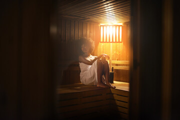 Black woman, sauna and detox at spa for self care, healing with wellness and zen at luxury resort. Relax, calm and peace on pamper day with heat or warm body treatment, skincare and stress relief