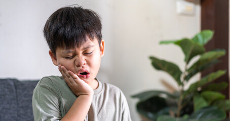 Young child experiencing toothache, embodying childhood dental pain. The child facial expression,...