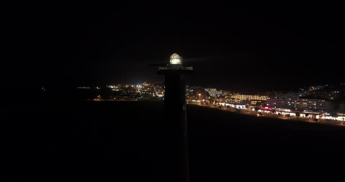 Jandia lighthouse at night aerial drone shot circling