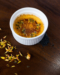 Yellow Dessert Garnished with Passion Fruit and Sprinkled with Cinnamon.