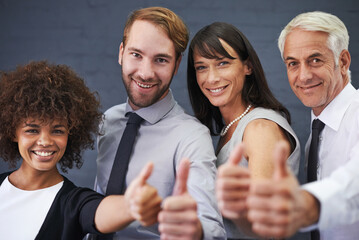 Business people, teamwork and thumbs up in studio portrait for success, winning and achievement or thank you emoji. Professional group with mature boss for like, yes and feedback on a wall background