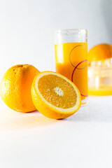 glass of orange juice and oranges