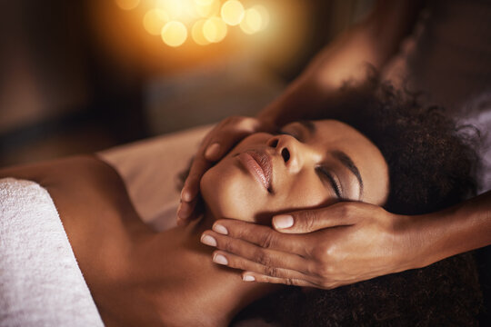Black woman, hands on face and massage with masseuse, beauty and bodycare at spa for stress relief and wellness. Treatment, skin and facial with healing for zen, self care and relax at luxury resort