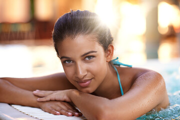 Happy woman, portrait and relax with water in jacuzzi for holiday, getaway or stress relief at...