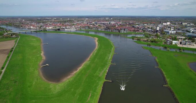 Explore stunning aerial views of boats gliding along rivers with cityscapes in the backdrop. Elevate your content with our high-quality stock footage.