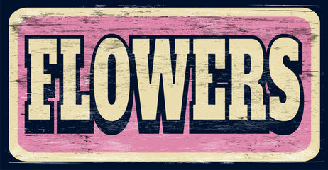 Aged and worn flower shop sign on wood