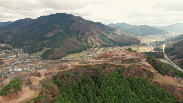 Japanese Mountain Range Valley Aerial Drone Landscape Drone Flying Above Outskirts of Kyoto in Takeda Castle Ancient ruins, hyogo asago