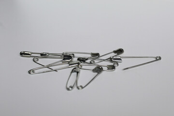 Some metal safety pins, isolated on white background