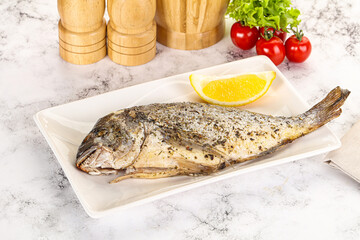 Baked Dorado fish served lemon