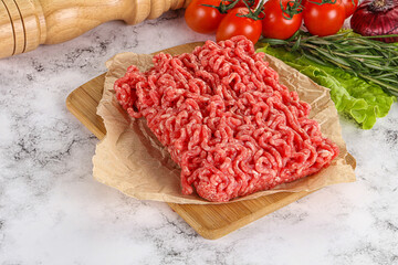 Raw minced beef meat on cutting board