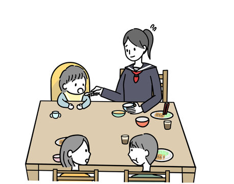 小さい子と食事をする学生の女の子