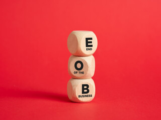 The abbreviation EOB end of the business on wooden cubes with red background.