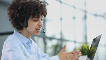 a girl in a modern office working in a call center concentrates on explaining the procedure