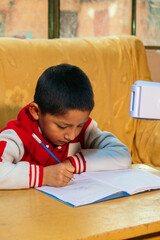 responsible latino child copying school assignments from cell phone - concept of responsibility
